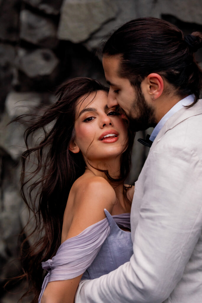 Romantic portrait of bride and groom during their Iceland adventure elopement on the black sand beaches of southern Iceland.