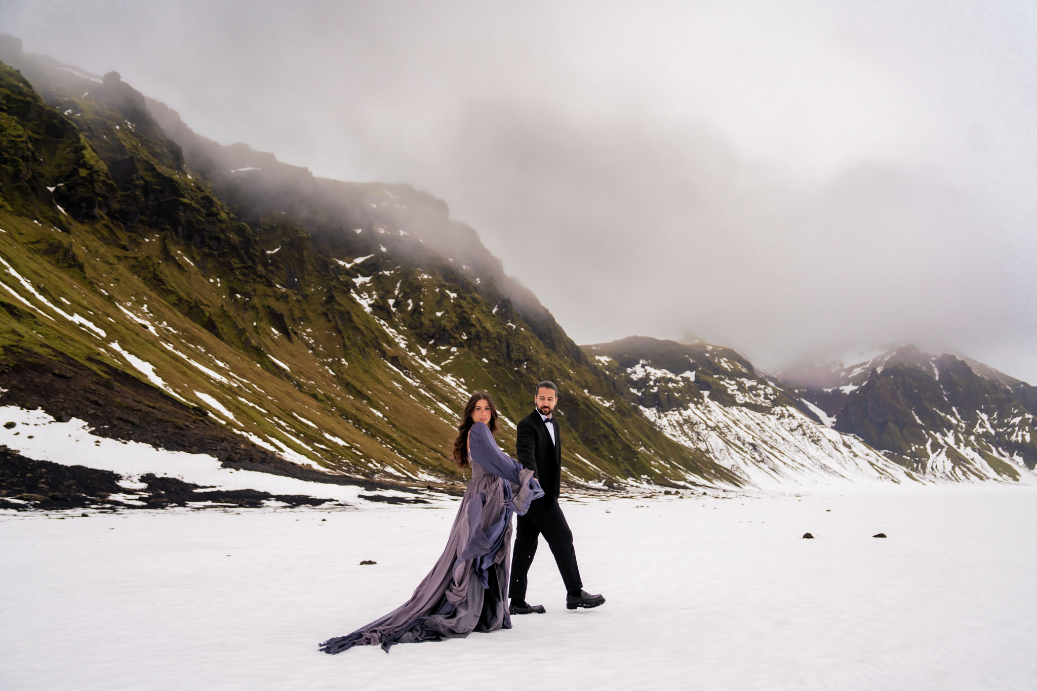 Couple standing together inside the Katla ice cave during their Iceland glacier elopement adventure.