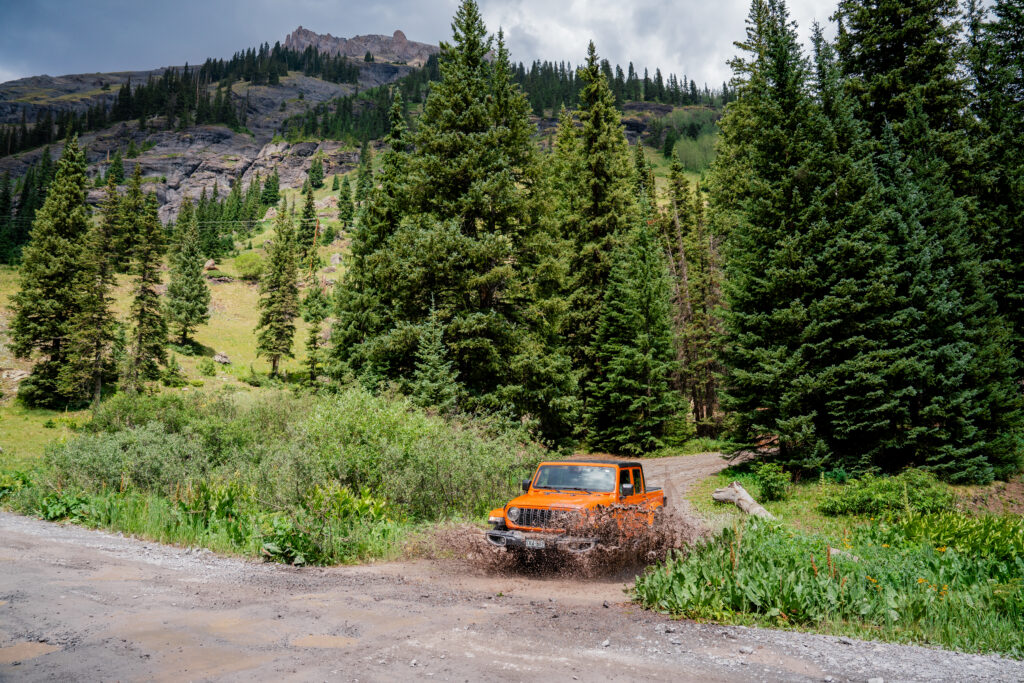 Jeep splashing through a shallow creek crossing while exploring Yankee Boy Basin near Ouray, Colorado.